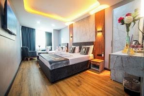 A modern hotel room with a large bed, bedside tables, a desk, and a bathroom. - Dual Hotel (Istanbul)