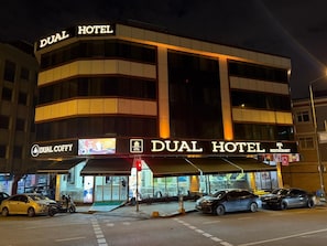 A hotel with a prominent sign reading "DUAL HOTEL" and a "DUAL COFFY" sign below. - Dual Hotel (Istanbul)