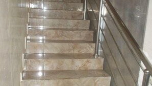 A marble staircase with metal railings. - LELUX HOTELS (Umuahia)