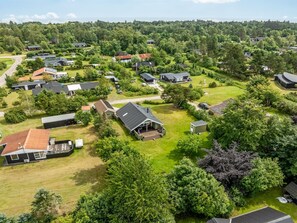 An aerial view of a residential area with houses, green lawns, and trees. - "Emiljan" -  from the sea by Interhome (Hals)