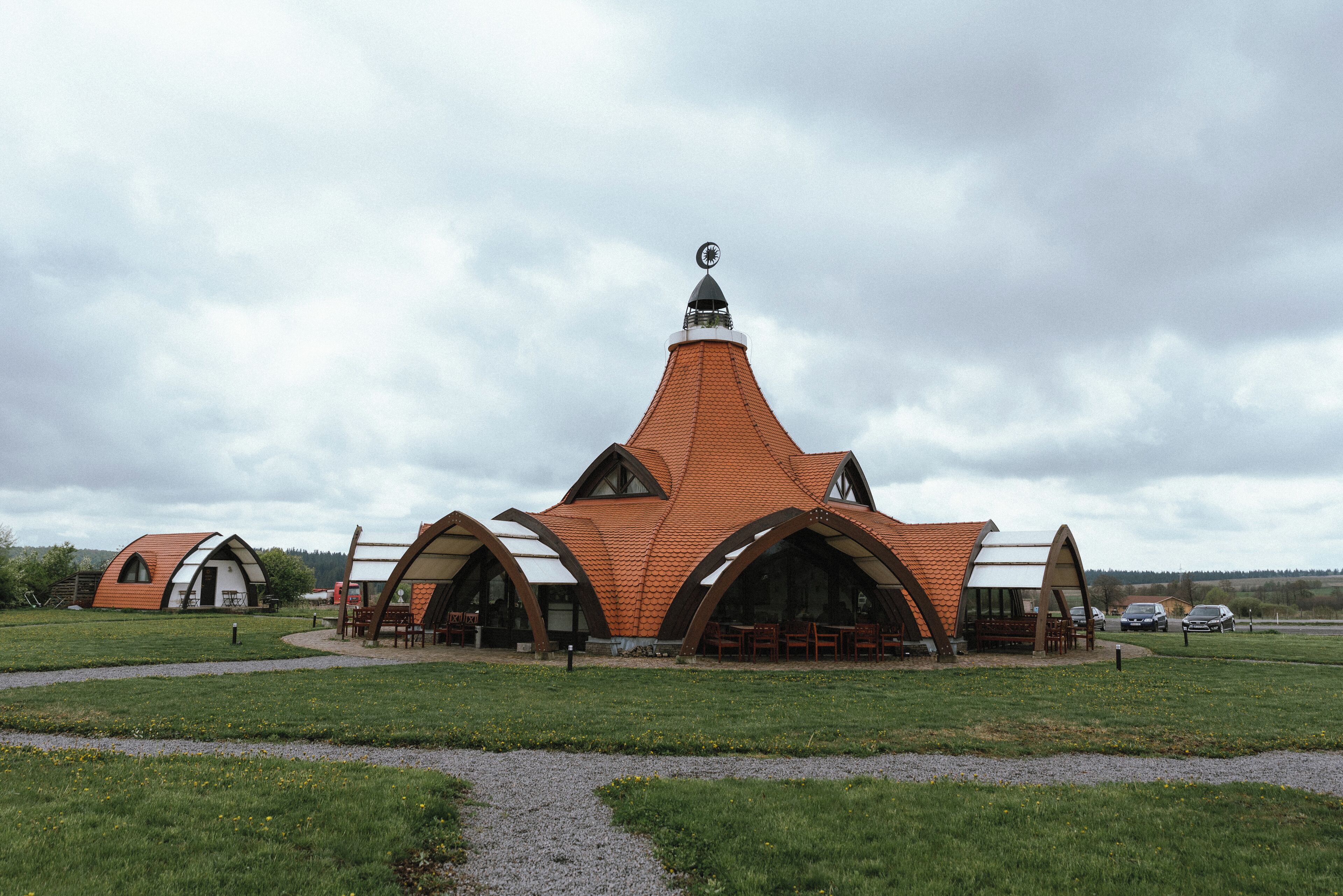 A building with a distinctive curved roof and a central tower.