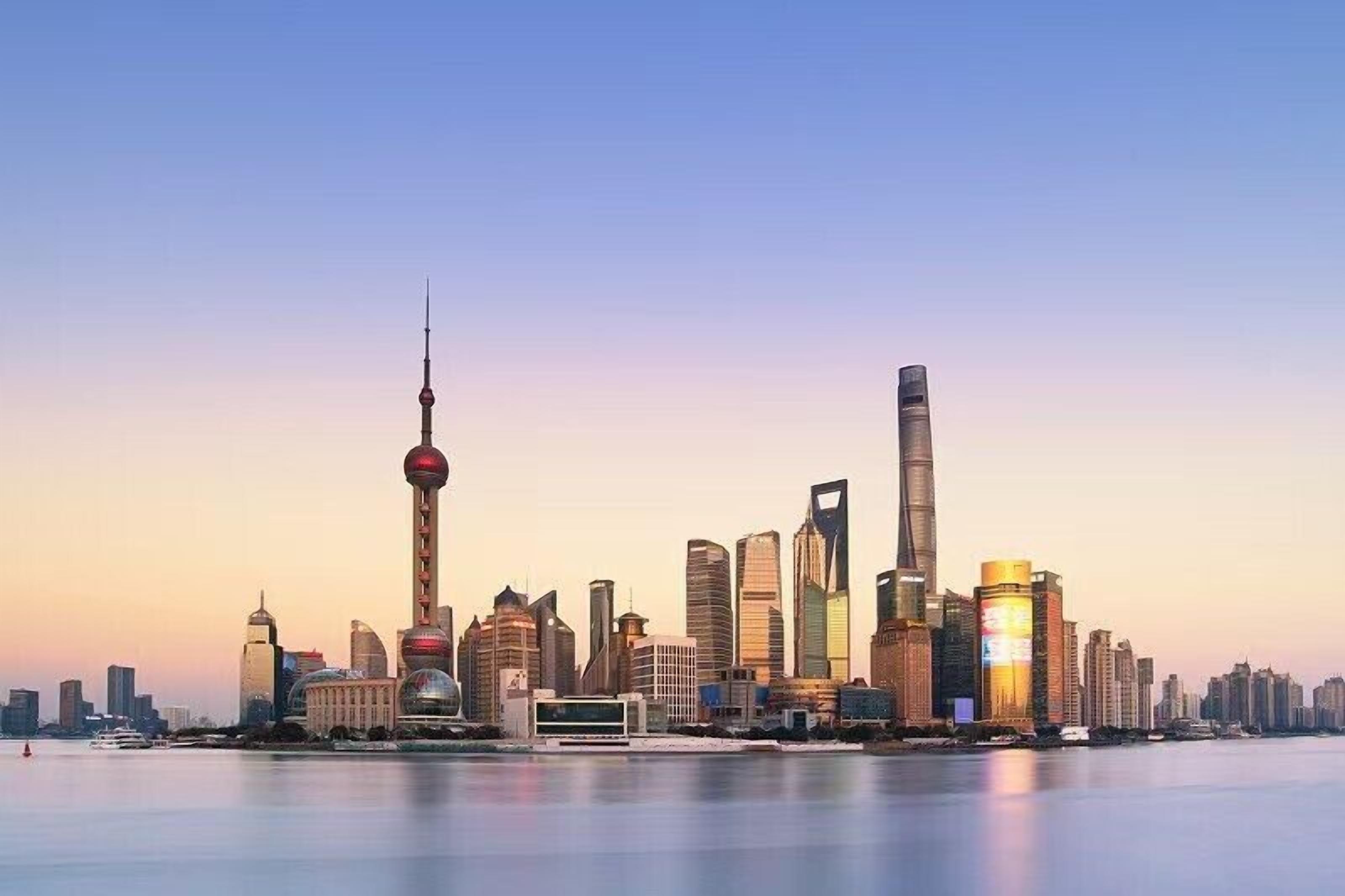 A city skyline with modern skyscrapers, including a distinctive tower with a spherical observation deck.