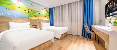 A hotel room with two beds, a desk, a chair, a TV, and a mural on the wall.