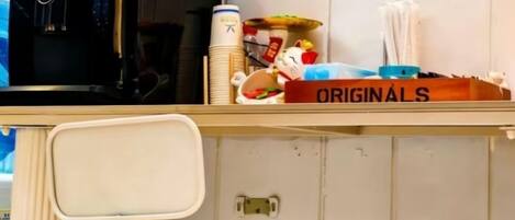 A room with a desk, a chair, a computer, and a red emergency phone.