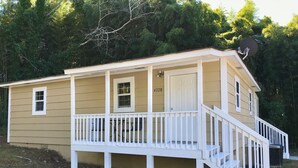 A two-story house with a front porch, a satellite dish, and a mailbox. - Bungalow by the Lake (Gainesville)