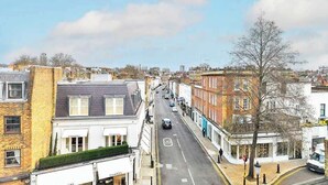 A street view with buildings, a road marked with a speed limit sign, and a clear sky. - The Elden - No.15 (Greater London)