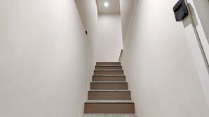 A narrow stairway with a light fixture at the top and a wall-mounted device on the right. - B&B La Rugiada with Wi-Fi (Pratomorone)