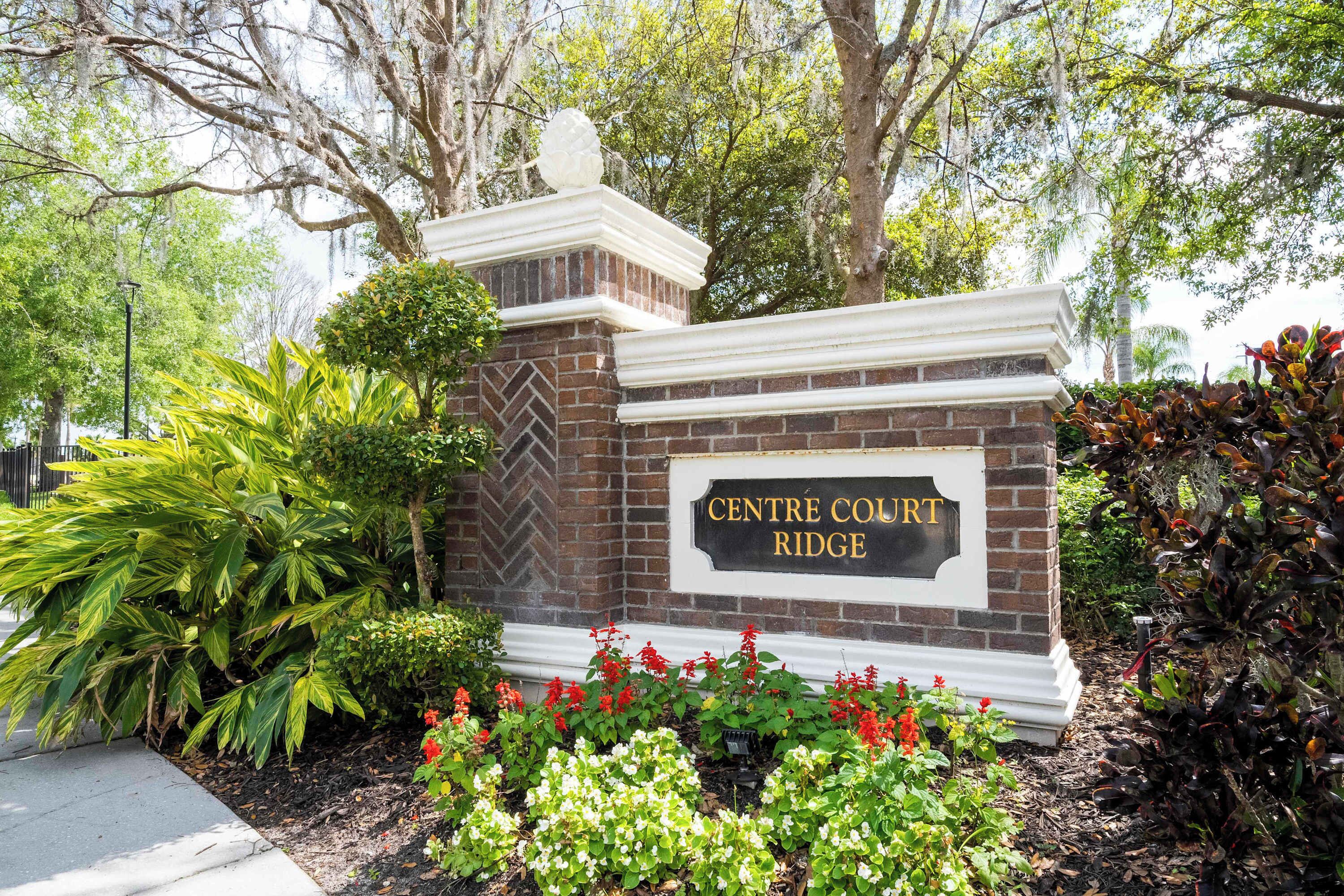 A brick entrance with a sign reading "Centre Court Ridge".