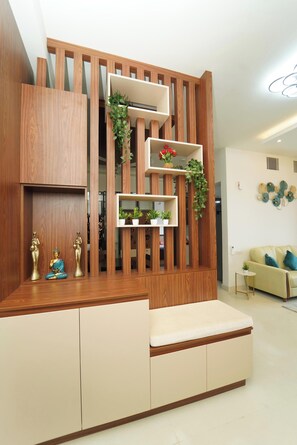 A modern living room with a wooden partition, a sofa, and a small table. - Auric Blue by Red Olive3bhkomrprime IT Corner (Chennai)