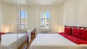 A bedroom with a bed, a desk, a chair, and a window. - Orcagna by MMega Homes and Villas (Florence)