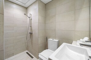A modern bathroom with a shower, toilet, and sink. - Studio Minutes to Downtown (Dubai)