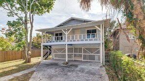 A two-story house with a covered porch and a fenced backyard. - Walk to Winter Haven Hospital: Convenient Apt (Winter Haven)