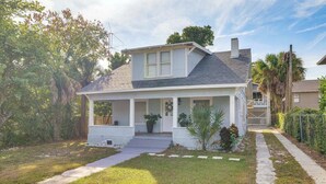 A single-story house with a front porch, a small front yard, and a pathway leading to the entrance. - Walk to Winter Haven Hospital: Convenient Apt (Winter Haven)