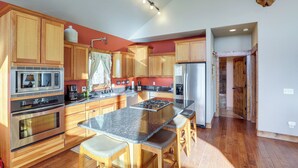 A modern kitchen with wooden cabinets, stainless steel appliances, and a granite countertop. - 1 Mi to Terry Peak! Black Hills Cabin Hideaway (Lead)