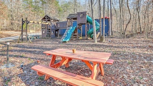 A playground with a slide and climbing structures, surrounded by trees. - 16 Mi to Lookout Mtn: Glamping Tent w/ Hot Tub (Trenton)