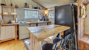 A compact kitchen with wooden countertops, a stove, and a refrigerator. There are hanging lights and a window providing natural light. - Hikers Hideaway w/ Hot Tub Near Lookout Mountain (Trenton)