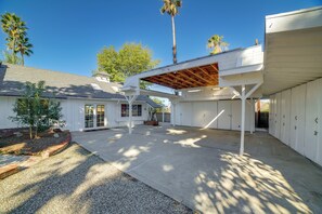 A covered outdoor area with a concrete floor, white walls, and a wooden pergola. - Spacious Riverside Farmhouse, Perfectly Located (Riverside)