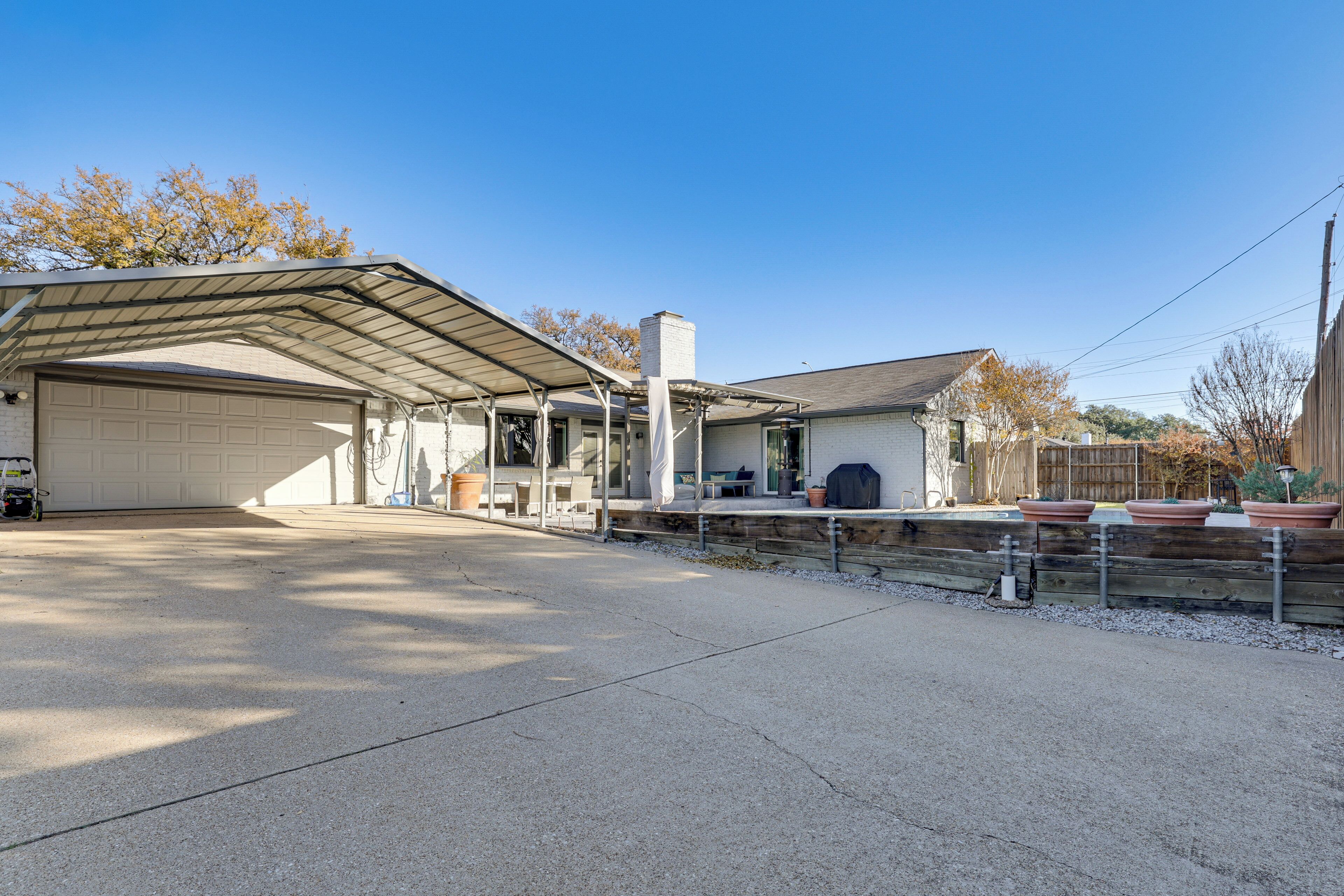 A single-story building with a covered garage and a patio area.