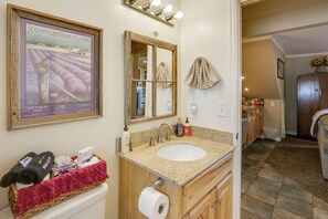 A bathroom with a framed poster, a sink, a mirror, and a towel rack. - 6 Mi to Dtwn Fort Collins: Cozy Apt w/ Shared Yard (Fort Collins)