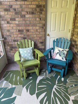 Two Adirondack chairs with patterned cushions, a brick wall, and a door. - Beautiful 1st Floor, Pet Friendly Condo in Barefoot Landing  (North Myrtle Beach)