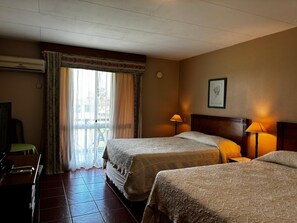 Standard Quadruple Room, Garden View | Minibar, in-room safe, blackout drapes, soundproofing - Los Naranjos Hotel (Dayman)