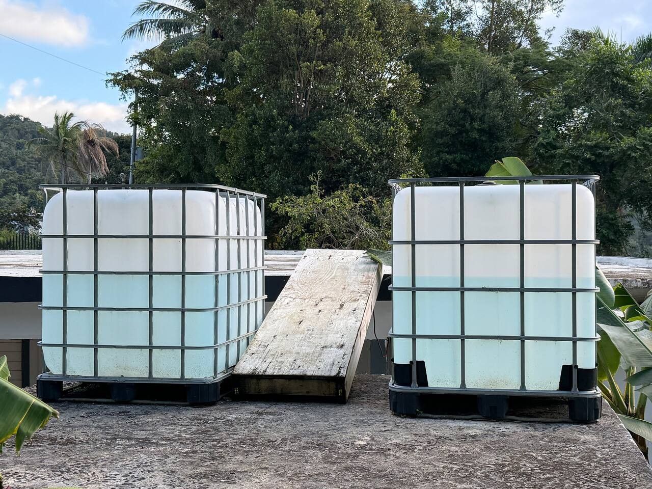 Dos objetos grandes, blancos y rectangulares con un diseño de cuadrícula, sobre una superficie plana al aire libre.