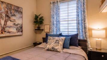 Relax in the master bedroom featuring a comfortable queen-size bed, air conditioning, ceiling fan, Smart TV, and a large closet for extended stays. Designed for comfort and convenience, it’s the perfect retreat after a day exploring.