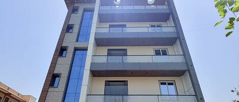 A multi-story building with a sign reading 'SHRI PREM SHARNAM' at the entrance.