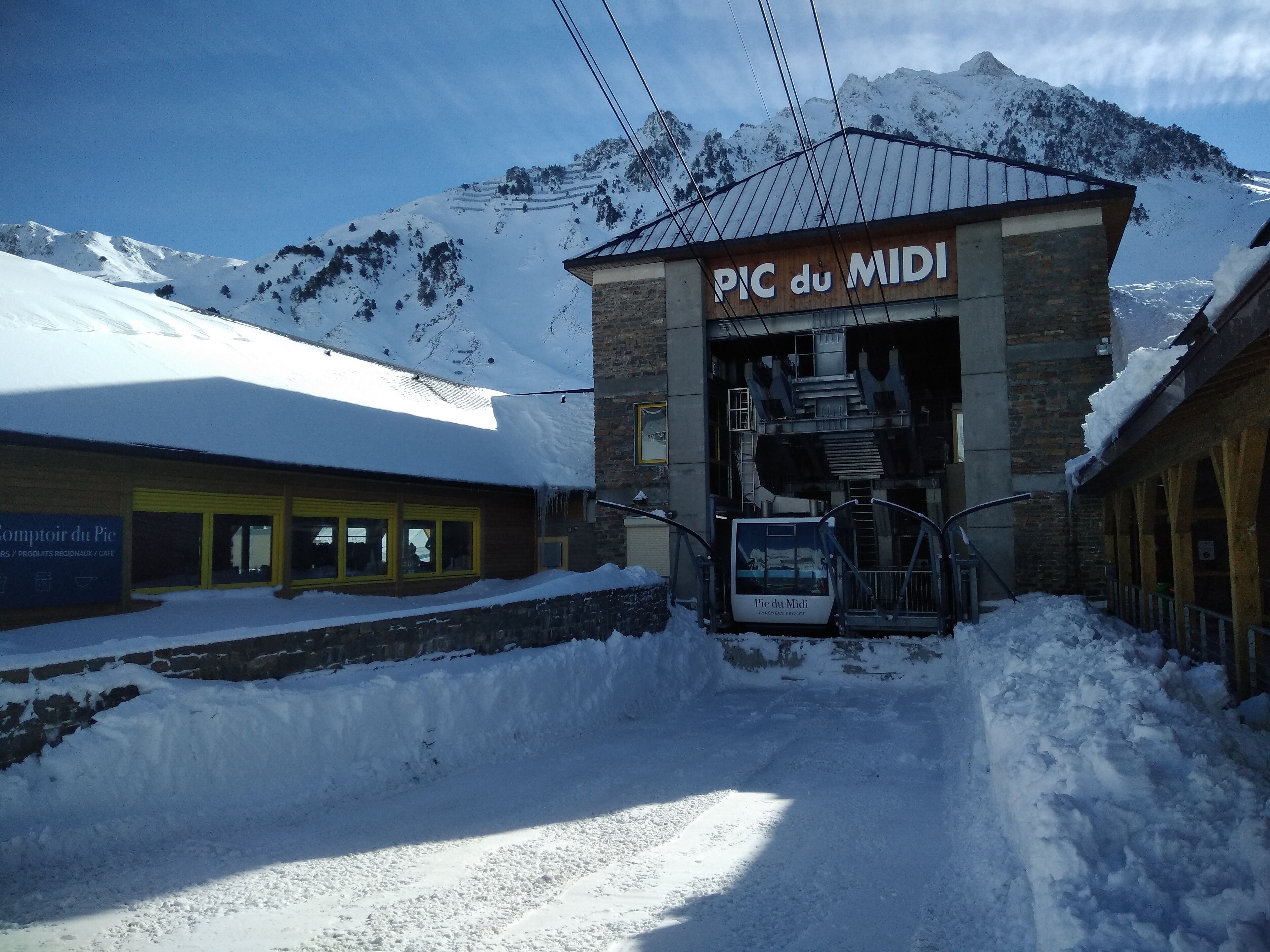 A snow-covered mountain with a building labeled "PIC du MIDI" in front.