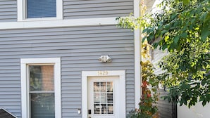 A two-story house with a front door labeled "1429" and a small porch with a wooden railing. - Charming 1901 Home, Modern Updates, Near Lake Superior (Duluth)
