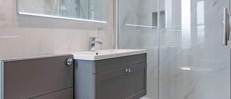 Shower, hair dryer, towels, soap