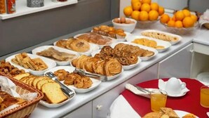 A buffet with various pastries, bread, and fruits. - Suisse Hotel - Alger Centre (Algiers)