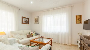 Una sala de estar con un sofá, una mesa de centro, un televisor y una chimenea.