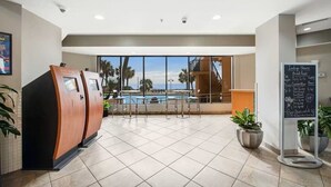A hotel lobby with a pool view, a sauna area, and a bar. - Cozy 1-Bedroom Oceanfront Condo in Myrtle Beach (Myrtle Beach)