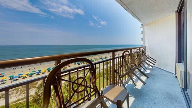 A balcony with a view of the beach and ocean. - Cozy 1-Bedroom Oceanfront Condo in Myrtle Beach (Myrtle Beach)