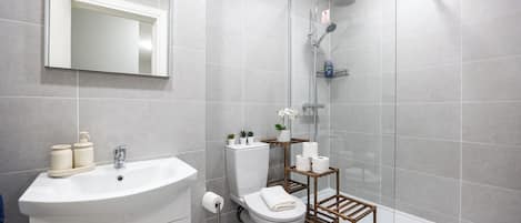 Shower, hair dryer, towels, toilet paper