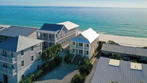 A beachfront hotel with multiple buildings, a beach view, and a clear sky. - Rooftop Deck, Paddle Boards, Gulf Front on 30A (Inlet Beach)