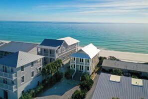 A beachfront hotel with multiple buildings, a beach view, and a clear sky. - Rooftop Deck, Paddle Boards, Gulf Front on 30A (Inlet Beach)