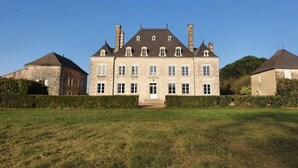 A large, historic building with multiple windows and a symmetrical facade. - Chambre Colibri, Country panorama and refined comfort at Domaine de la Briouse (Sanxay)