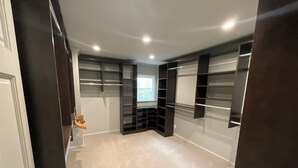 Een kamer met inbouwkasten, een deur en een raam.