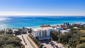 A coastal hotel with a parking lot, a swimming pool, and a view of the sea. - The Viridian 201 (Santa Rosa Beach)