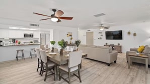 A modern living space with a dining area, kitchen, and seating area. - Backyard Paradise in Chandler (Chandler)