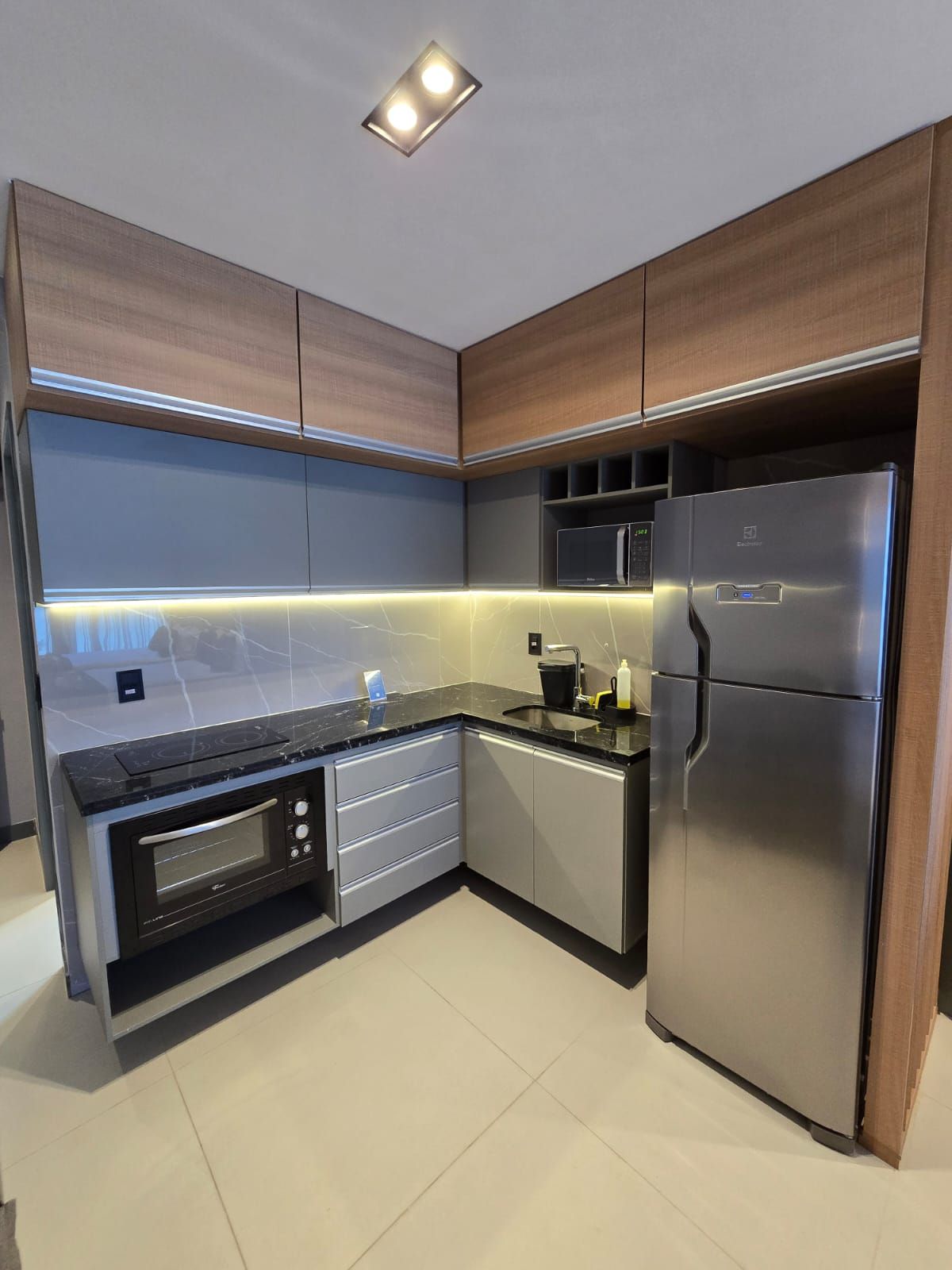 A modern kitchen with built-in appliances, including a microwave, oven, and refrigerator.