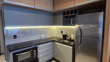 A modern kitchen with built-in appliances, including a microwave, oven, and refrigerator.