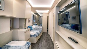 A compact hotel room with two beds, a desk, and a large mirror. - La Casetta by PortofinoVip [AC-Super central]. (Portofino)
