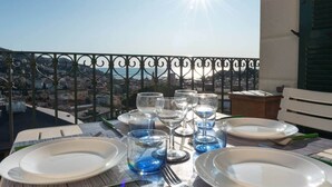 A table set for dining with a view of a cityscape. - Cosy Apartment by PortofinoVip [Parking-Seaview] (Rapallo)