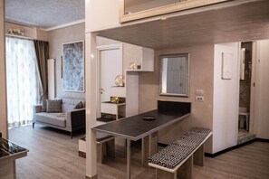 A compact living space with a dining area, a sofa, and a small kitchen. - My Room SML by PortofinoVip [10 people-AC]. (Santa Margherita Ligure)