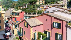 A hillside residential area with colorful buildings, balconies, and a cobblestone street. - Terrace by PortofinoVip [Parking-Terrace-AC] (Portofino)