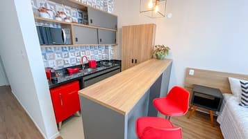 Fridge, microwave, coffee/tea maker, cookware/dishes/utensils