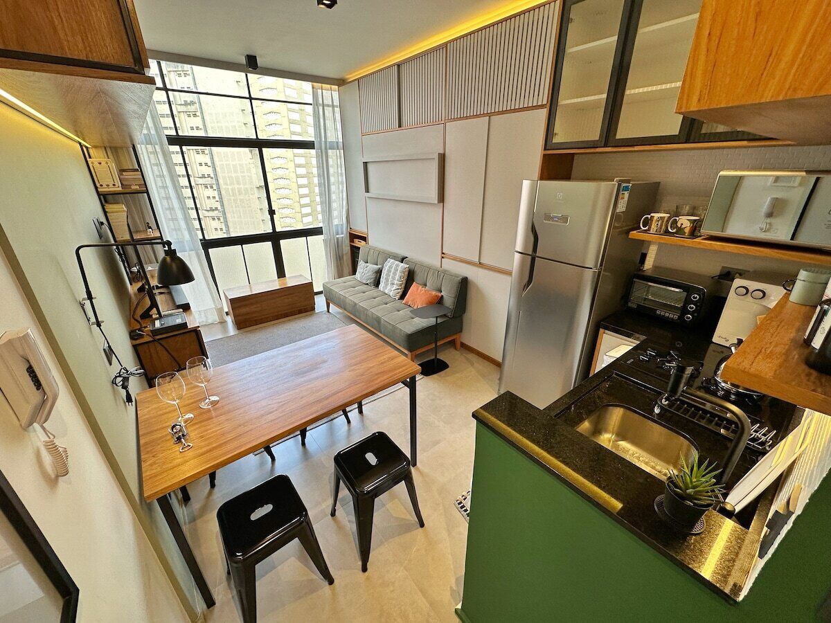 A compact kitchen with a dining area, a built-in oven, and a microwave.